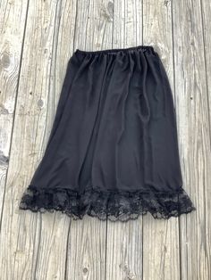 Pretty lace ruffles under slip. Chiffon fabric Skirt or Slip with adjustable elastic waist. Large size Slip measurement  28 inches wide elastic adjustable waist  26 inches long from top of of waist to bottom of ruffles.  4 inches long lace ruffles.  Hand spot wash only.  Hang dry. Stretch Lace Skirt With Ruffles, Lace Skirt With Ruffles And Stretch, Skirted Stretch Bottoms With Lace Trim, Stretch Tiered Skirt With Lace Trim, Stretch Lace Trim Skirt, Lace Petticoat With Lace Trim And Tiered Skirt, Daywear Lace Petticoat With Lace Trim, Black Stretch Skirt With Lace Trim, Lace Skirt Black