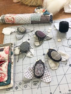 several pieces of fabric are laid out on a table with scissors and other sewing supplies