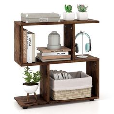 a shelf with books, plants and other items on it in front of a white background