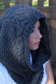 a woman wearing a gray knitted hat and scarf