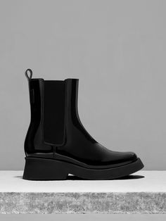 Ace your transeasonal footwear game by adding the Giselle boots to your wardrobe rotation. Featuring a versatile and chic Chelsea boot silhouette, this iteration features a black patent finish for a sleek and sophisticated shine that will elevate your every outfit. Bonus points for the 5.5cm chunky block heels, which offer a moderate height boost that does not compromise on comfort. Sleek Patent Leather Heeled Boots For Work, Modern Patent Leather Heeled Boots For Winter, Chic Patent Leather Platform Boots For Winter, Chic Winter Patent Leather Platform Boots, Modern Patent Leather Winter Heeled Boots, Sleek Patent Leather Boots For Work, Modern Patent Leather Boots For Fall, Modern Patent Leather Boots For Winter, Modern Patent Leather Winter Boots