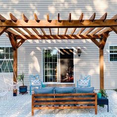 a wooden pergolan sitting on top of a patio