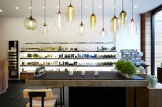 a store with lights hanging from the ceiling and bottles on the counter in front of it