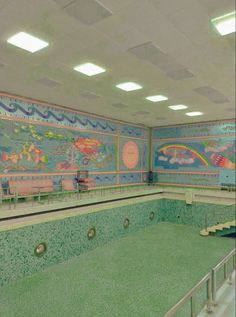 an empty swimming pool with painted walls and steps leading up to the upper level area