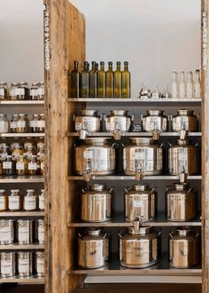 the shelves have many pots and pans on them