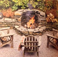 an outdoor fire pit with chairs around it