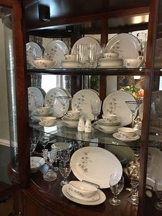 a china cabinet filled with dishes and glasses