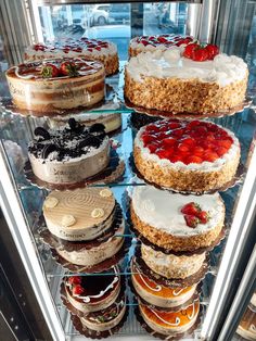 a display case filled with lots of cakes