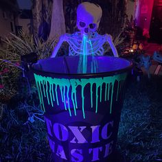 a halloween decoration in the shape of a trash can with neon green and purple paint