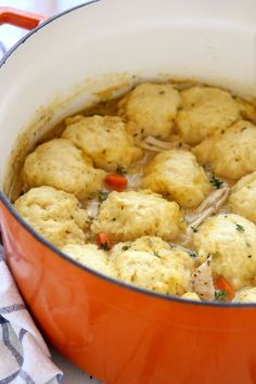 a pot filled with dumplings sitting on top of a table