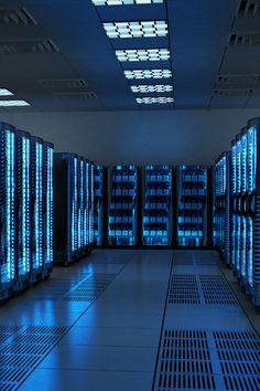 rows of servers in a data center with blue lights on the ceiling and flooring