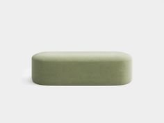 a green soap bar sitting on top of a white surface