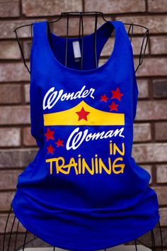 Wonder Woman in Training Workout Tank - Funny Tank Top Moisture-wicking Stretch Cotton T-shirt, Blue Graphic Print T-shirt For Training, Pre-shrunk Cotton Sleeveless T-shirt, Fitted Blue T-shirt For Training, Blue Fitted T-shirt For Training, Cotton Tank T-shirt With Letter Print, Pre-shrunk Cotton T-shirt For Training, Stretch Cotton Moisture-wicking Tank Top, Stretch Cotton Tank Top With Moisture-wicking