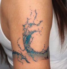 a woman's arm with water splashing on it