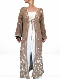 Sakura is a unique, hand-crocheted, and hand-embroidered duster cardigan, perfect for summer days. Crafted from premium cotton yarn, this sustainable piece has just landed in BALSTROND's slow-fashion knitwear collection. With its elegant straight silhouette, wide long sleeves, sheer geometrical pattern, and versatile camel colour, this lace summer coat is an exquisite addition to any wardrobe. Adorned with delicate sakura blossoms and delicate beading, it is truly a one-of-a-kind, eye-catching i Sakura Blossoms, Summer Coat, Fashion Knitwear, Knitwear Collection, Summer Coats, Geometrical Pattern, Embroidered Cardigan, Knitwear Fashion, Cardigan Long