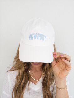 A dad style hat with a low crown, curved bill and adjustable back strap. Available in a white canvas with a light blue embroidered "Newport" graphic on the front. White Snapback Visor Hat With Letter Print, White Letter Print Snapback Visor Hat, White Letter Print Visor Snapback Hat, White Cotton Snapback Dad Hat, White Adjustable Dad Hat For Streetwear, White Adjustable Dad Hat With Curved Brim, Trendy White Snapback Hat With Curved Visor, White Curved Visor Dad Hat For Streetwear, White Hat With Embroidered Logo And Curved Visor