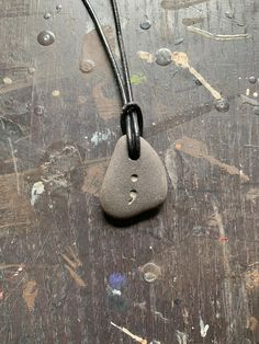 "- This particular stone features a semicolon and measures approximately 1\"x 1\". - Hand etched black necklace made from genuine Canadian stone. - Each necklace is completely one of a kind and handetched. - Includes durable leather cording (approximately 30\" in total length). - Will come shipped securely in a bubble mailer." Semicolon Necklace, Rock Carving, Semi Colon, Black Beach, Rock Jewelry, Stone Feature, Beach Stones, Homemade Jewelry, Bubble Mailer