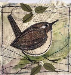 a bird is sitting on top of a piece of fabric with leaves and lace around it