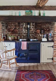 a rocking chair in front of an old fashioned stove