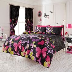 a bed room with a neatly made bed and pink flowers on the bedspread