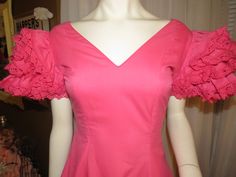 "Maybe 60's/70's lovely pink ruffle-listic dress, ankle-length, by Creaciones, in a size 7/C. Great Quinceanera celebration wear, with V-neck-off shouldered fitted bodice, huge ruffled 4 layered sleeves, and the skirt part is tapered at the waist, with and 8 layered ruffled skirt. The dress has a nylon back zipper closure, and in photo 6 & 7, is not zipped all the way to the top/back, because my mannequin is a slight too large for it. Dress is of cotton fabric, and is a little weighty from s 1970s Fitted Ruffle Vintage Dress, 1970s Vintage Dress With Ruffles For Summer, Spring Vintage Dress With Ruffles For Formal Occasions, Spring Vintage Fitted Dress With Ruffles, Fitted Vintage Dress With Ruffles For Spring, Fitted Retro Vintage Dress With Ruffles, Retro Fitted Vintage Dress With Ruffles, Spring Formal Vintage Dress With Ruffles, Vintage Pink Dress With Ruffles