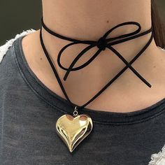 "The Amore Necklace 🤍 Featuring an XL gold stainless steel puffy heart pendant, and a 48\" cut suede string cord. There are a ton of ways to wear this necklace (you can even wear it as a waist belt!) and if you need a custom length, DM me!  Unisex & tarnish proof 🖤 1.5\" wide, 1.25\" long Made with love 🫶" Trendy Adjustable Heart Necklace For Party, Adjustable Trendy Heart Necklace For Party, Trendy Party Choker With Heart Pendant, Trendy Party Heart Choker Necklace, Heart-shaped Gold Jewelry For Fashion, Trendy Heart Charm Choker For Party, Trendy Party Choker With Heart Charm, Trendy Heart Pendant Choker For Valentine's Day, Valentine's Day Heart Charm Choker For Party