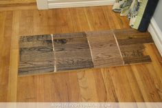 wood flooring samples laid out on the floor in front of a door and window