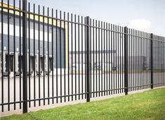 a black metal fence next to a building