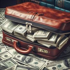 a suitcase full of money sitting on top of a pile of hundred dollar bills