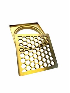 a metal grate with honeycombs on the bottom and one hole in the middle