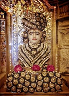 the statue is decorated with gold and red flowers