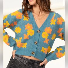 Cropped Teal Cardigan With Yellow And Orange Daisy Print. V Neckline. Button Down Center. Soft Thick Sweater Material. Blue Cardigan With Buttons For Spring, Blue Button Cardigan For Spring, Blue Cardigan For Spring, Cute Button-up Cardigan For Fall, Cute Fall Cardigan With Button Closure, Cute Button-up Fall Cardigan, Orange Cardigan With Button Closure For Spring, Spring Orange Cardigan With Button Closure, Orange V-neck Cardigan For Spring