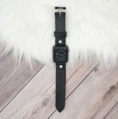 Perfect for those who love a simple natural look. Our natural leather is of the highest quality and softest material. Every piece cut from the leather is unique, with its own imperfections and natural marks. Each band is just as distinctive as our skin, unlike anyone else’s, and with its own story to tell. Apple Watch Buckle Band Black leather stitched to black Leather Embellishments and Adapters will be matched to Apple Watch Color Approximately 1" wide Adjustable buckle closure Apple Watch Colors, Square Watch, Natural Look, Casio Watch