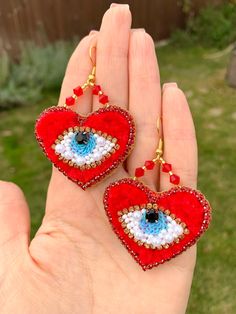 Embroidered red beaded evil eye earrings, Handmade long scarlet heart earrings, These are cool earrings for a gift, they will be a talisman for you against the evil eye. Such earrings, this is a best sellin items handmade Talisman earrings will protect you from the evil eye The size of this earrings is 5 centimeters high and 2,5 centimeters wide Dear customer,  I promise to make and send you your order in 3-5 working days!  - Delivery to the U.S. takes 2-7 weeks. - Delivery to Australia takes 2-8 weeks (more often 3 weeks, but I can not promise it) - Delivery to Europe takes about 2-7 weeks. Welcome to Lovely little things! One of my passions is embroidery. Everything I design and create sparks a desire in me to share it with the world. Red Beaded Earrings, Beaded Evil Eye, Red Bead Earrings, Earrings Cool, Cool Earrings, Scarlet Heart, Evil Eye Earrings, Eye Earrings, Red Bead