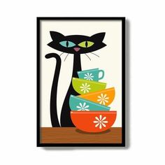 a black cat sitting next to a stack of colorful cups on top of a wooden table