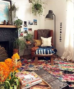 a living room filled with lots of furniture and flowers in vases on the floor