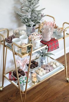 a gold serving cart filled with christmas treats