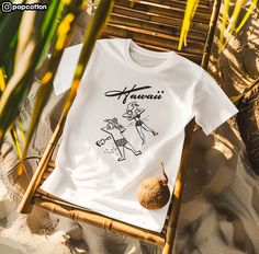 "Retro Hawaii Sunbathers" unisex tee Direct-to-Garment printed on Bella + Canvas 3001 unisex t-shirt. PLEASE REVIEW LAST PHOTO for details showing size and color charts. Follow Pop Cotton on Instagram at @popcotton for updates on new items. We drop new designs very frequently! *Not all t-shirts worn by the models in the photos are the Bella + Canvas 3001 unisex tee. RETURN POLICY NO RETURNS or EXCHANGES but contact me anyways if you have any issues. I'm sure we can work something out. Cancellations are accepted if you message me within 1 HOUR from the time of purchase to ensure order hasn't gone into production. All inquiries welcome! I look forward to hearing for everyone so feel free to send me a message. THANK YOU for checking out this listing and thank you for your support! Beach Season Streetwear T-shirt With Screen Print, Screen Print T-shirt For Beach Season Streetwear, Retro Surfing T-shirt For Beach Season, Retro Letter Print T-shirt For Beach Season, Retro Fan Merchandise T-shirt For Summer, Retro T-shirt With Letter Print For Beach Season, Retro White Print T-shirt For Summer, Vintage Graphic Print T-shirt For Beach Season, White Pre-shrunk T-shirt For Surfing