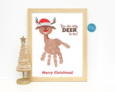 a christmas card with a reindeer handprint on it