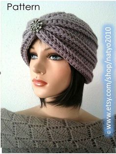 a mannequin head wearing a gray knitted hat