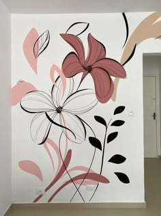 an empty room with flowers painted on the wall