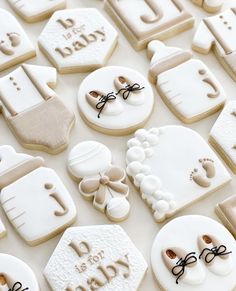 baby shower cookies are arranged on a table