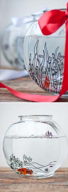 two glass vases with designs on them, one is empty and the other has red ribbon