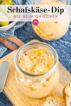 a glass jar filled with food sitting on top of a cutting board next to bread