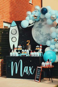 a space themed birthday party with balloons and decorations