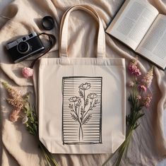 Need a holiday gift idea or a simple thoughtful gift? Elevate your everyday style with our exquisite Floral Line Art Tote Bag!  Perfect for line art lovers seeking a chic canvas to express their passion, eco-conscious shoppers looking for sustainable yet stylish options, and busy students or professionals who need a versatile bag for books and laptops. Grab yours today and bloom wherever you go! ‣ Tap here to head back to the shop: https://www.etsy.com/shop/FukuDesignsUS ‣ Follow us on: IG - htt Artistic Beige Bags For Gifts, Artistic Beige Bags Perfect For Gifts, Line Art Lovers, Bag For Books, Flower Print Design, Floral Tote Bag, Painted Tote, Art Tote Bag, Design Line