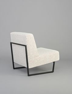 a white chair sitting on top of a gray floor