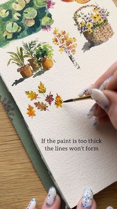 a woman is painting flowers and plants on a piece of paper with watercolor pencils