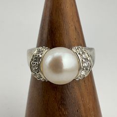 Vintage Cubic Zirconia & Pearl Sterling Silver Ring, UK Size M1/2, US Size 61/4, EU Size 52, Stamped 925 DQCZ Diamond Quality Cubic Zirconia, Front Max Width 9.6mm, Weight 5.84 Grams, Lovely Condition Classic Anniversary Rings With Rhinestones, Classic Rhinestone Rings For Formal Occasions, Classic Formal Rings With Rhinestones, Formal Rings With Rhinestones, Formal Diamond Ring With Rhinestones, Classic Formal Rhinestone Rings, Anniversary Diamond Ring With Rhinestones, Formal Rhinestone Diamond Ring, Luxury Cubic Zirconia Round Cut Pearl Ring