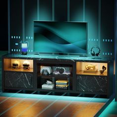 an entertainment center with marbled cabinets and lights on the sides, in front of a television screen